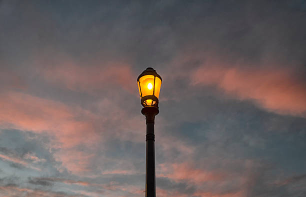 istock Street lamp lit at dusk 494183134