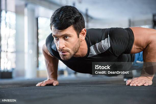 Man Doing Push Ups In Gym Stock Photo - Download Image Now - Push-ups, 2015, Activity