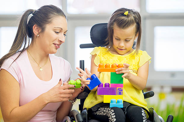 istock Mentally Disabled Girl Playing with Blocks 494183308