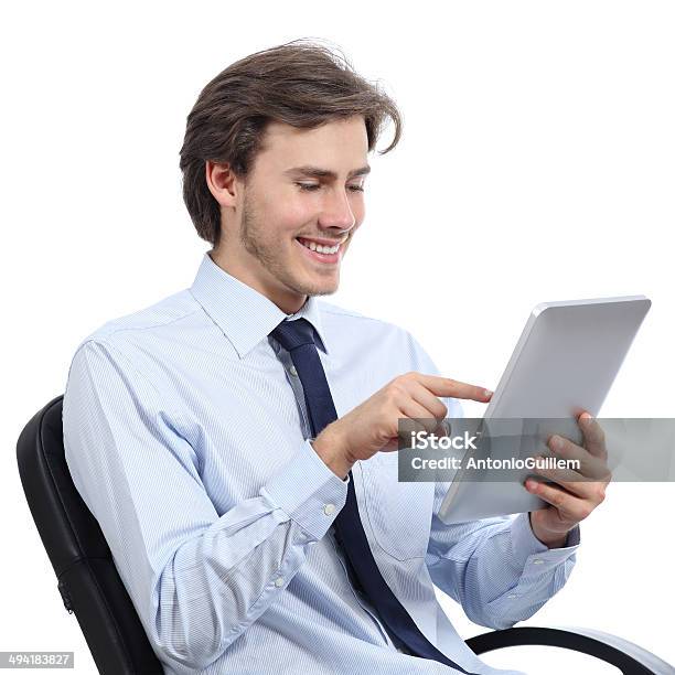 Executive Sitting On A Chair Browsing A Tablet Stock Photo - Download Image Now - Adult, Beautiful People, Beauty