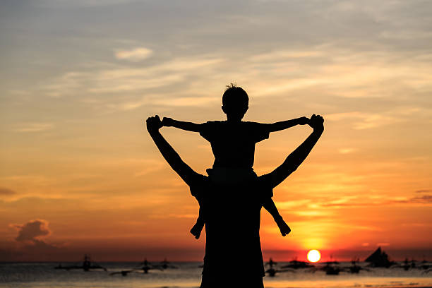 istock happy family on sunset beach 494185439