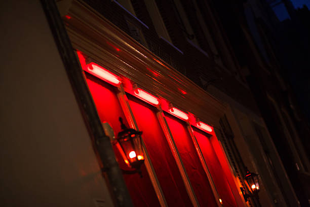 Red lights of sex cabins in Amsterdam Red lights of sex cabins and windows in Wallen of Amsterdam at night. wellen stock pictures, royalty-free photos & images