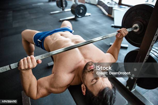 Muscular Man Doing Bench Press Stock Photo - Download Image Now - 2015, Activity, Adult