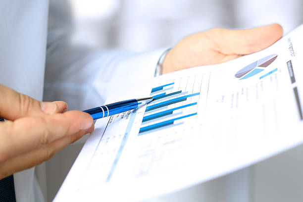 istock young businessman showing graphs by pen 494189696