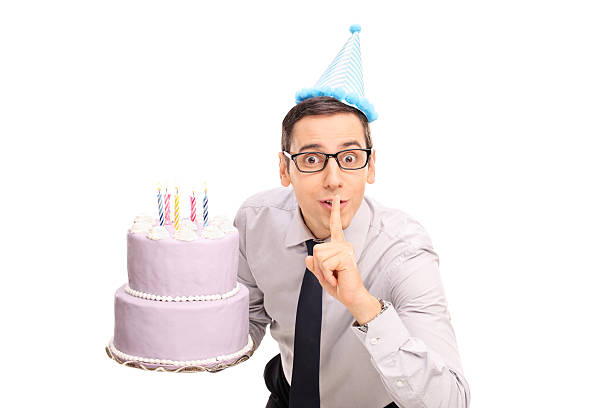 istock Joyful young man holding a birthday cake 494190542