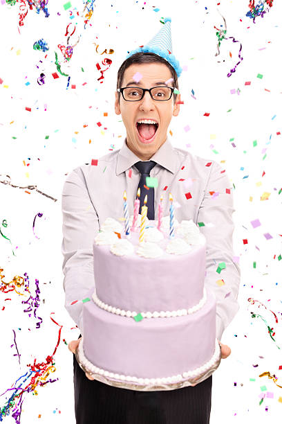 istock Young joyful man holding a birthday cake 494190782