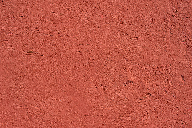 istock Texture of old wall covered with red stucco 494192304