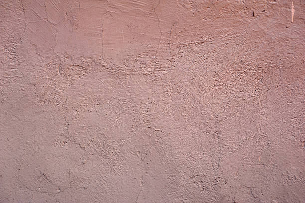 istock Texture of old wall covered with pink stucco 494192448