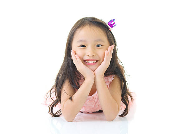 Close-up of a young Asian girl lying on the floor with a disappointed expression, showing emotional contrast during Chinese New Year at home