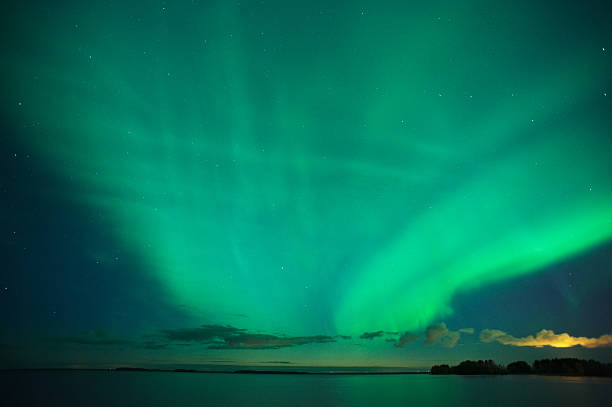 Aurora Borealis Aurora Borealis above lake after sunset. 10 sec exposure with high ISO 800. Moderate level of noise. finnish lapland autumn stock pictures, royalty-free photos & images