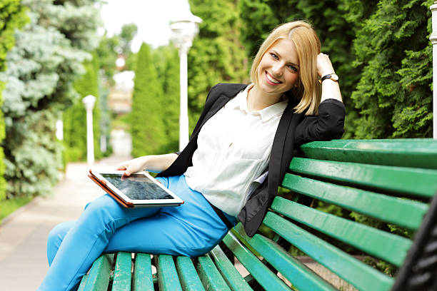 istock Smiling woman sitting on the bench 494206255