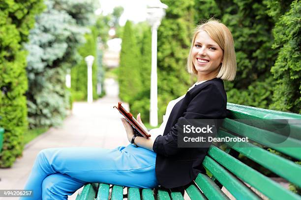 Happy Woman Sitting On The Bench Stock Photo - Download Image Now - Adult, Adults Only, Beautiful People