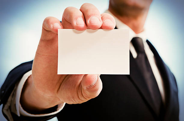 istock Man's hand showing business card. 494208549