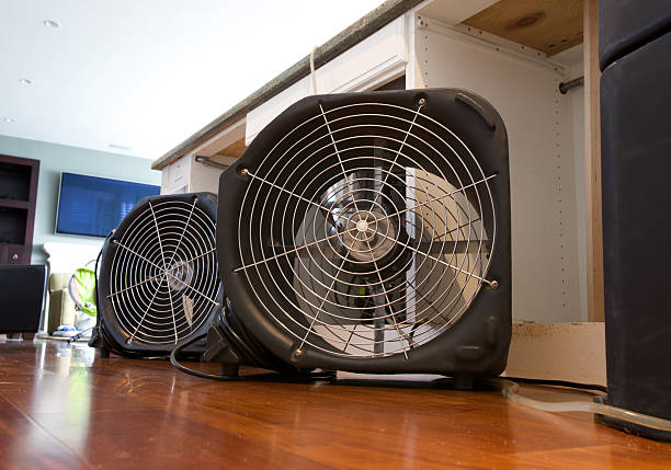 Water Damaged Kitchen Cabinets Two industrial fans running to dry out water damaged residential kitchen island from leak. floor fan stock pictures, royalty-free photos & images