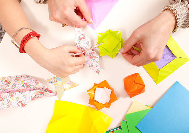 istock hands make something from sheet of paper 494209255