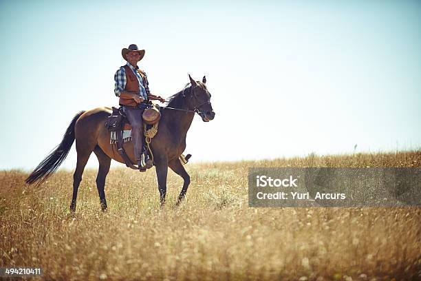 Riding On The Plains Stock Photo - Download Image Now - Ranch, Texas, 40-49 Years