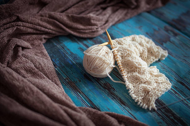 istock knitting with white woolen thread, knitting with braids 494213932