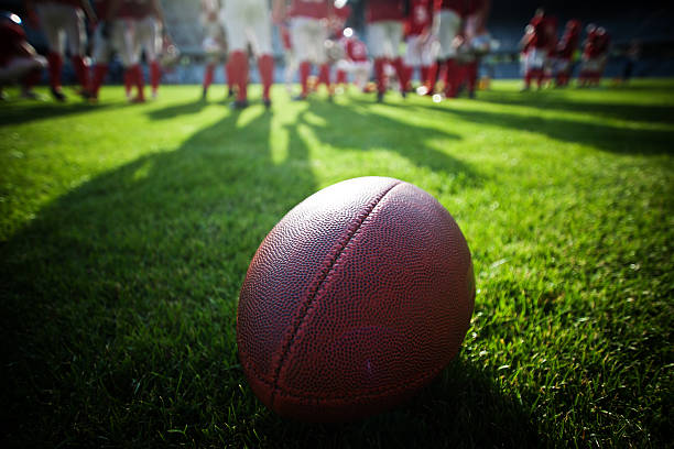 Close up of an american football on the field stock photo