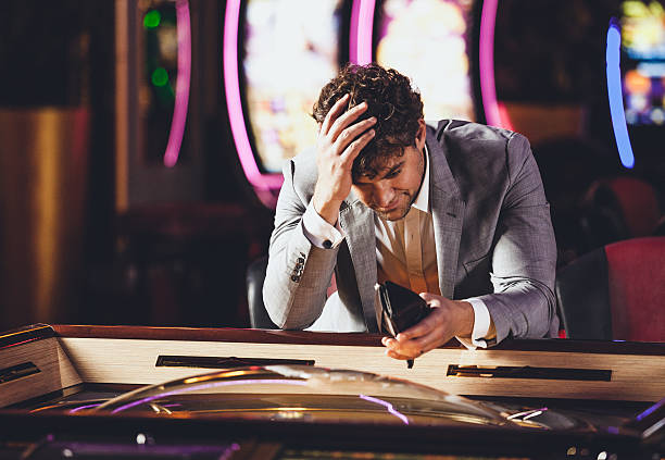 Loosing at the Casino Man loosing at the Casino defeat stock pictures, royalty-free photos & images