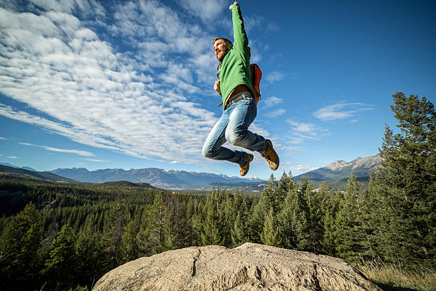 istock Young hiker man jumping high up on a mountain top 494217930