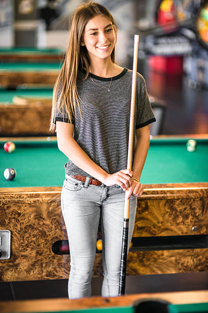 istock Happiness girl standing in a pub at the pool table 494221028