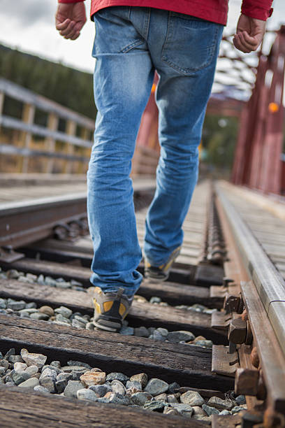 istock Traveling man walking on the railroad track 494221066