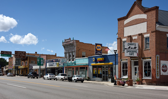 Panguich, United States - September 16, 2015: Highway 89, North Main Street, Panguitch, Utah, USA, looking south-west. An array of individual commercial premises aimed at both local and tourist clients including a cafe, auto parts, thrift and antiques stores, one specialising in cowboy memorabilia. Unidentified people.