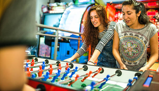 istock friends playing foosball at the arcade game 494225266