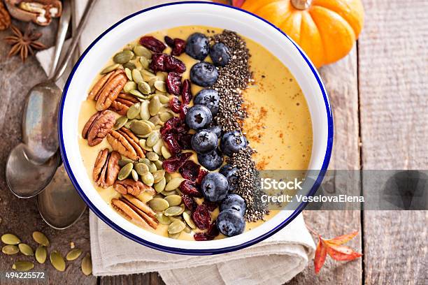 Pumpkin Smoothie Bowl With Chia Seeds Pecans Cranberries Stock Photo - Download Image Now