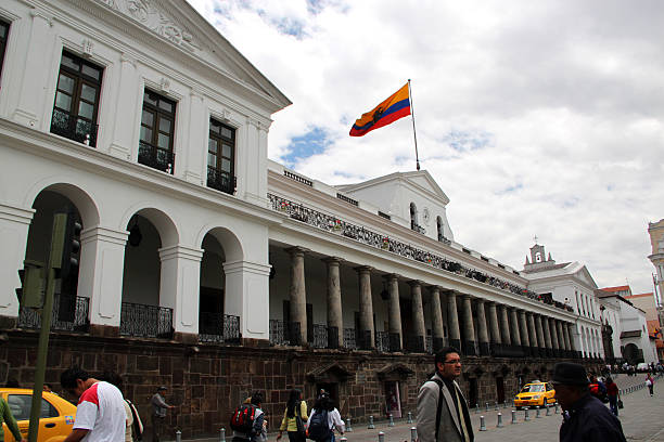 Quito, Ecuador - August 24, 2010: Locals stroll by Carondelet Palace (Palacio de Carondelet), the seat of government of the Republic of Ecuador, located in Quito. Facing Independence Square or Plaza Grande, this historic building dates back to the 16th Century.