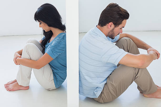 istock Sitting couple are separated by white wall 494236065