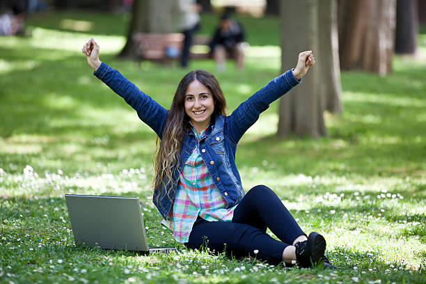 istock young woman surfing the internet in a park 494236965