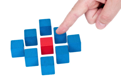 Isolated building blocks with pointing finger on white background