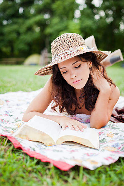 Laying down, reading stock photo