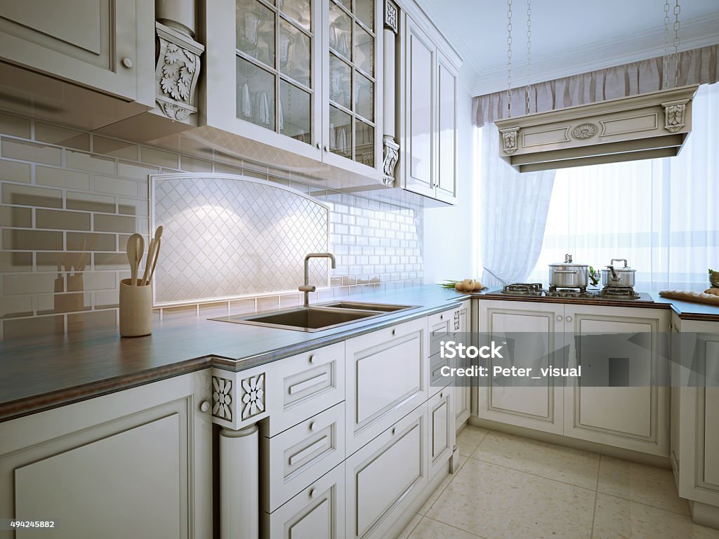 Traditional l-shaped eat-in kitchen Inspiration for a traditional l-shaped eat-in kitchen with an undermount sink, recessed-panel cabinets, snowy-white cabinets, granite countertops, stone tile backsplash and stainless steel appliances. Kitchen Stock Photo