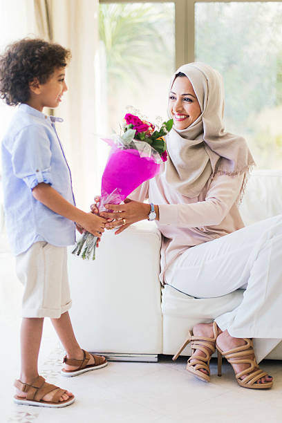 istock Son is giving flowers to her mother as a present. 494246540