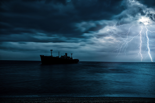 nautical vessel on the sea and thunderstorm in night time.