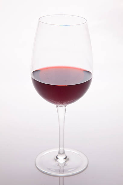 istock Red wine in a glass on white background 494252392