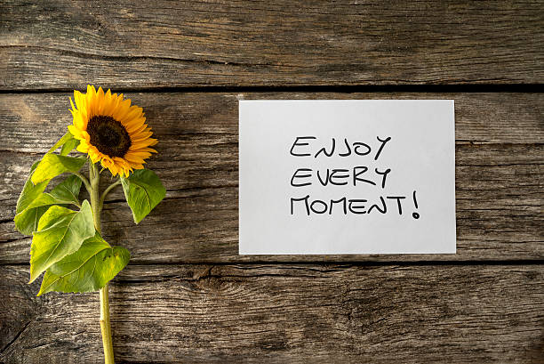 istock White card with an Enjoy every moment message 494255980