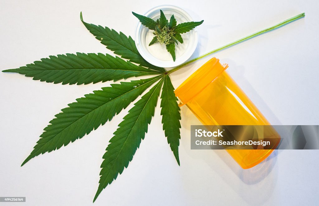 Marijuana and Prescription Bottle Marijuana leaf, bud, and prescription bottle (concept: medical marijuana). 2015 Stock Photo