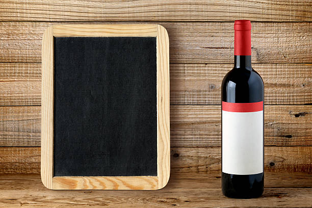 istock Bottle of red wine and blank blackboard 494256604