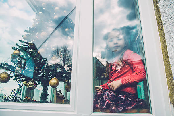 istock Girl Playing at Nativity Scene, Christmas Tree Through Window, Europe 494257532