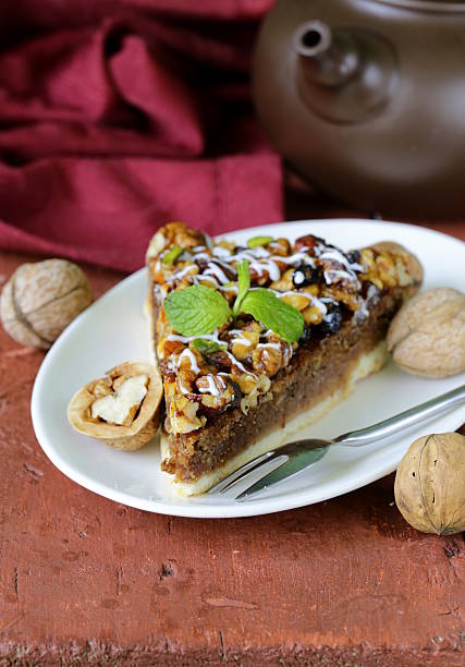 istock piece of pecan pie tart with various nuts 494258885