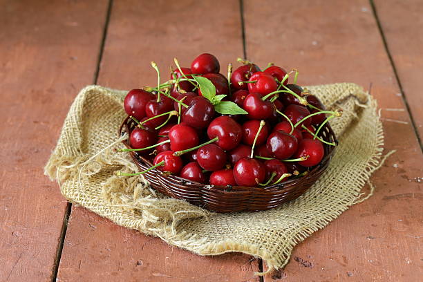 istock fresh red ripe cherries in wicker basket 494258895
