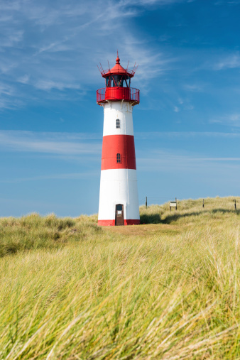 Lighthouse of Texel sticking out of the dunes.