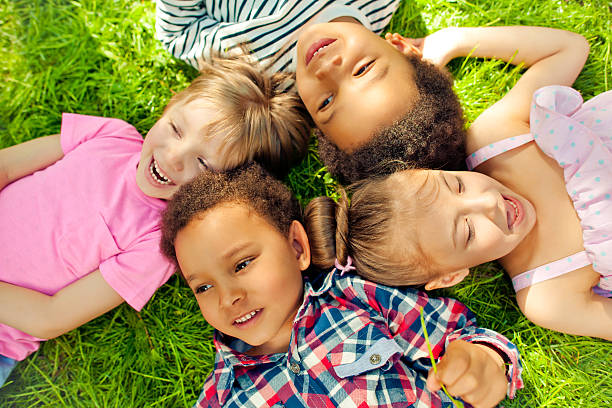 istock High angle view of children lying in a park 494261117