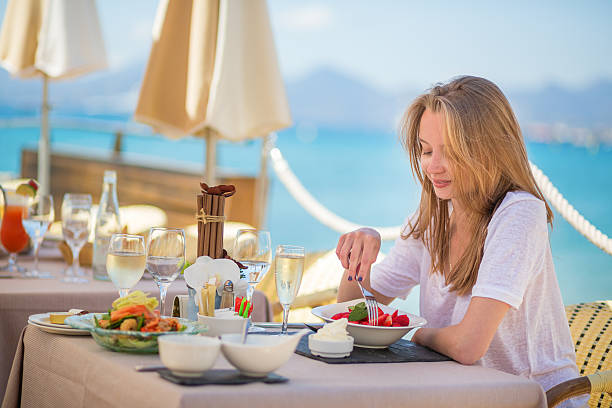 istock Beautiful young woman in a beach restaurant 494261155