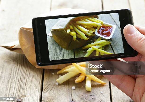 French Fries On Mobile Phone Screen Stock Photo - Download Image Now - Auto Post Production Filter, Blogging, Camera - Photographic Equipment