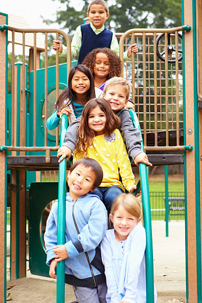istock Young Children Sitting On Climbing Frame In Playground 494262315
