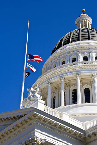 istock Flags at half staff dome of capital building 494263285